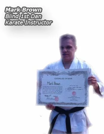 Mark Brown the Blind Karate Sensei posing with his black belt, he is a certified instructor despite been totally blind.